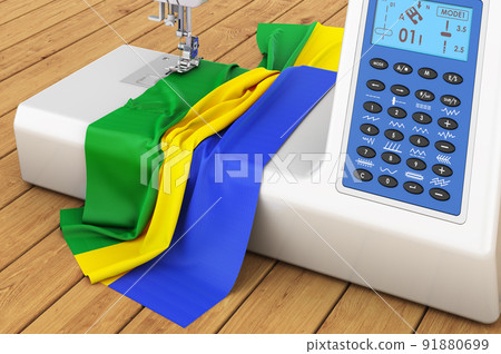 Sewing machine with Gabonese flag on the wooden table. 3D rendering 91880699