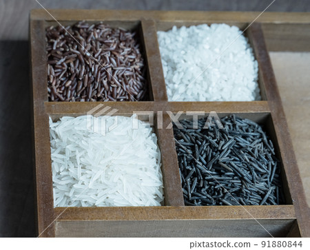 basmati rice black and red wooden box with sections close-up basmati rice black and red wooden box with sections close-up 91880844