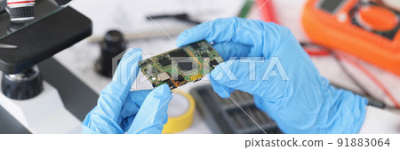 Technician hold component of digital device, repair smartphone at home Technician hold component of digital device, repair smartphone at home 91883064