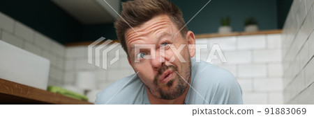 Man with funny facial expression on toilet seat, fulfill natural need 91883069