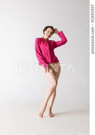 Portrait of young beautiful slim girl in underwear posing isolated over gray studio background. Wellness, wellbeing, fitness, fashion concept. Portrait of young beautiful slim girl in underwear posing isolated over gray studio background. Wellness, wellbeing, fitness, fashion concept. 91885997