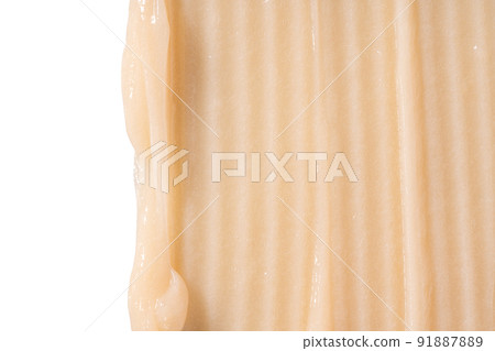 Hair conditioner cream swatch smear on white background. Yellow cosmetic lotion moisturiser sample closeup. Body care balm, retinol serum, shampoo wavy texture. Skincare mask, creamy cleanser 91887889