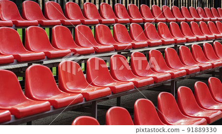 Rows of empty red outdoor stadium seats in perspective Rows of empty red outdoor stadium seats in perspective 91889330