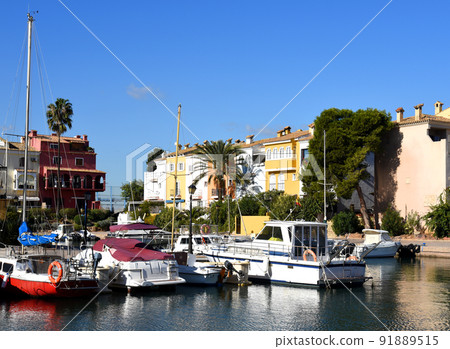Jetty with yacht. Yachts and motor boats in marina Port Saplaya, Valencia. Jetty with yacht. Yachts and motor boats in marina Port Saplaya, Valencia. 91889515