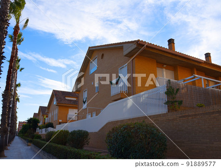 Brick house with palm trees in yard on street. Home with apartments at Alboraia, Patacona beach Brick house with palm trees in yard on street. Home with apartments at Alboraia, Patacona beach 91889577