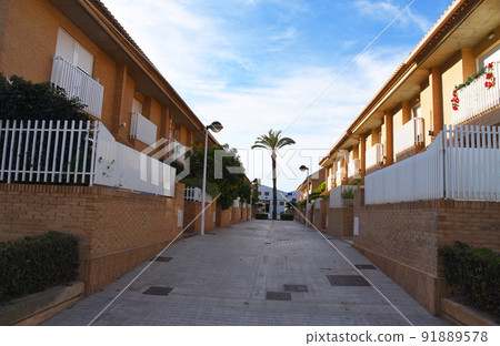 Brick house with palm trees in yard on street. Home with apartments at Alboraia, Patacona beach Brick house with palm trees in yard on street. Home with apartments at Alboraia, Patacona beach 91889578