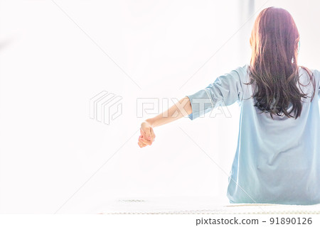 Young woman stretching to wake up Young woman stretching to wake up 91890126