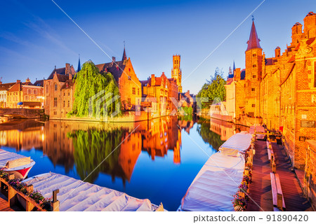 Bruges, Belgium. Rozenhoedkaai illuminated at night, old town with Belfry reflection 91890420