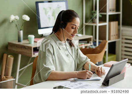 Businesswoman having online meeting at office Businesswoman having online meeting at office 91892490