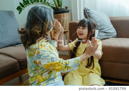Asian portrait, grandma and granddaughter doing leisure activities and hugging to show their love and care for each other. Asian portrait, grandma and granddaughter doing leisure activities and hugging to show their love and care for each other. 91892799