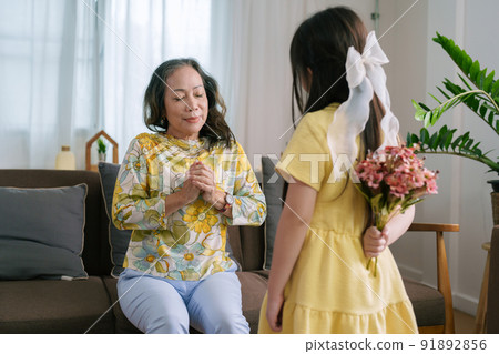Asian portrait, grandma and granddaughter doing leisure activities and hugging to show their love and care for each other. Asian portrait, grandma and granddaughter doing leisure activities and hugging to show their love and care for each other. 91892856