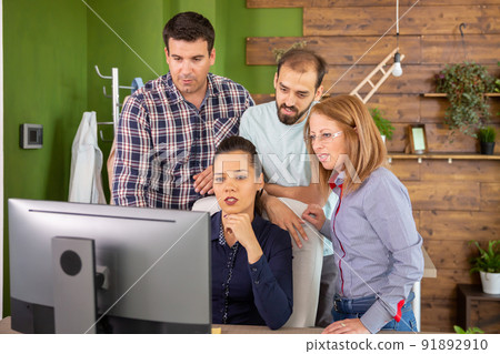 Young colleagues having a conversation with their female manager. Creative manager. 91892910