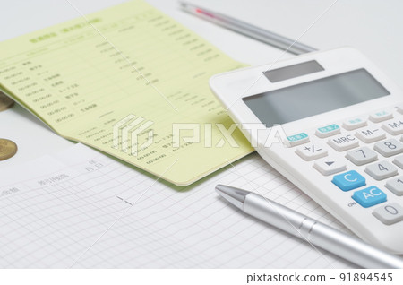 Image of calculating household budget with a calculator 91894545