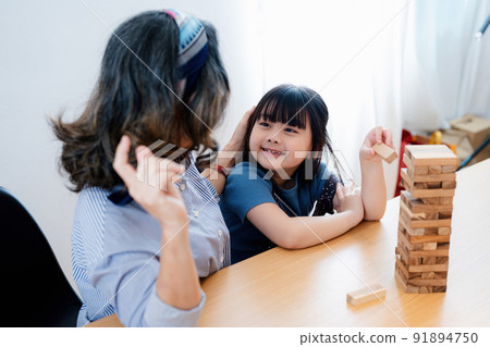 Asian portrait, grandchild granddaughter grandma grandmother and granddaughter happily join in activities to Block wood game Puzzle and enhance skills for grandchildren. 91894750