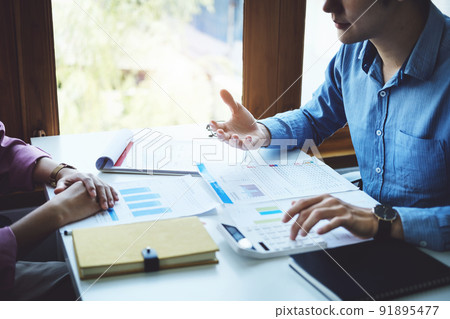 Teamwork concept, consultation, economist pointing budget, finance and investment documents, discussing and planning finances with advisors in conference room. 91895477
