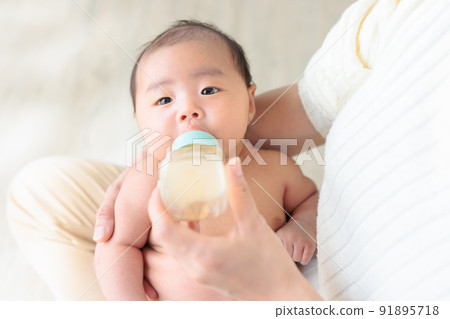 Baby drinking milk 1 month old copy space Baby drinking milk 1 month old copy space 91895718