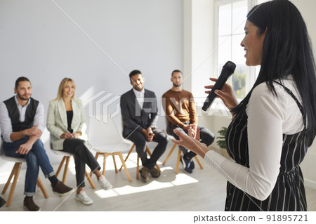 Smiling female coach talk at training with employees 91895721