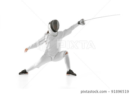 Young girl, beginner fencer in fencing costume and mask practicing with rapier isolated on white background. Sport, youth, healthy lifestyle, achievements. 91896519