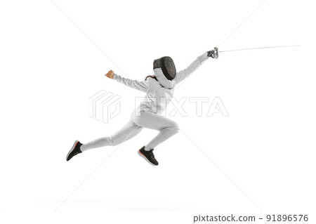 Dynamic portrait of female fencer in sports costume with rapier in hand training isolated on white background. Sport, youth, healthy lifestyle, achievements. 91896576