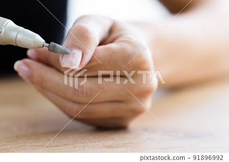 Removing shellac from the nails with fraser. Closeup. Selective focus. Removing shellac from the nails with fraser. Closeup. Selective focus. 91896992