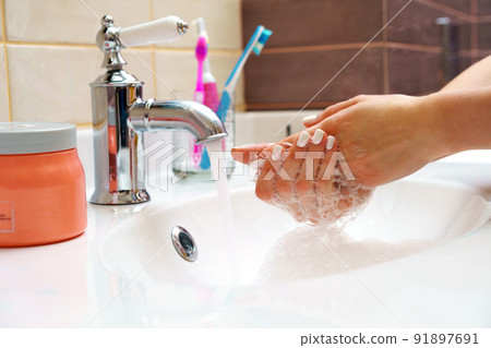 Woman washing her hands with soap close up 91897691