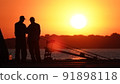 Silhouette of fishermen on the pier at sunset 91898118