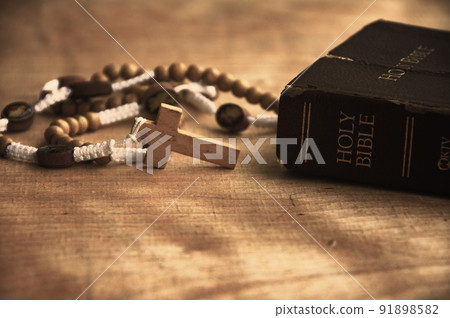Holy Bible and Rosary on a wooden table with customizable space to add ideas or text. Christianity concept. Holy Bible and Rosary on a wooden table with customizable space to add ideas or text. Christianity concept. 91898582