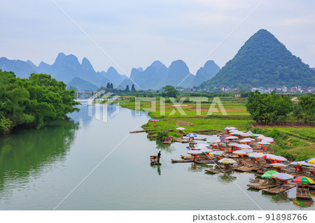 A landscape of the Yangshuo suburbs where the karst terrain of Guilin, China spreads A landscape of the Yangshuo suburbs where the karst terrain of Guilin, China spreads 91898766
