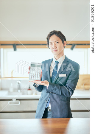 Home sales businessman with a calculator 91899201