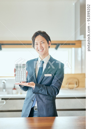 Home sales businessman with a calculator 91899202