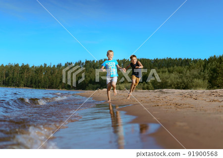 kids running alone esa side. Pine forest on background. Happy childhood concept. kids running alone esa side. Pine forest on background. Happy childhood concept. 91900568