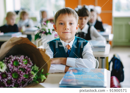 cute russian boy sitting at the desk in a classroom of new modern scool on 1st september cute russian boy sitting at the desk in a classroom of new modern scool on 1st september 91900571
