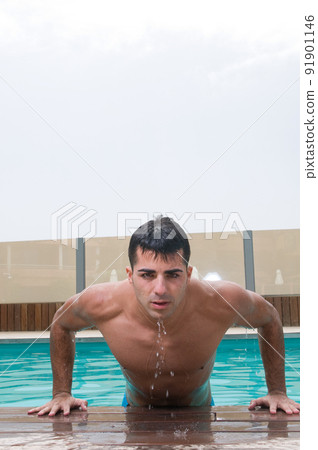 Sensual man in swimming pool 91901146