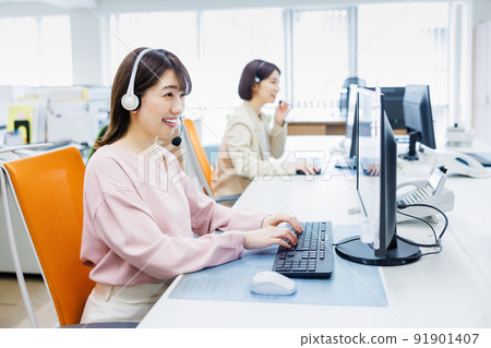 Young woman working in a call center 91901407