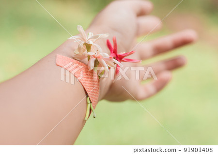 Dainty flowers plastered in a woman's wrist showing the concept of springtime, growth, healing, wellness and mental wellbeing 91901408