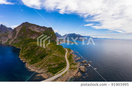 Road to Reine village surrounded by high mountains and sea on Lofoten islands 91903995