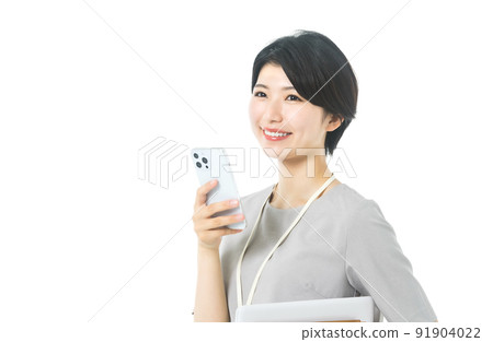 Female engineer in a young casual costume operating a smartphone (white background) Female engineer in a young casual costume operating a smartphone (white background) 91904022