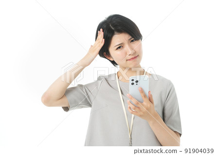 Female engineer in a young casual costume operating a smartphone (white background) Female engineer in a young casual costume operating a smartphone (white background) 91904039