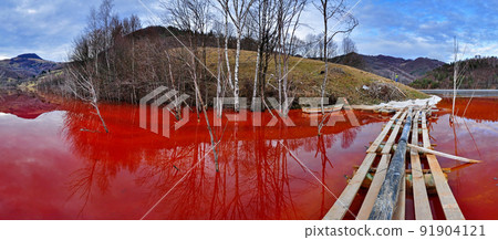 Environmental disaster. Panorama of a lake full with contaminated water from a mine in Geamana, Rosia Montana, Romania 91904121