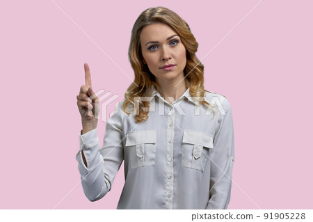 Confident thoughtful woman pointing finger up having excellent idea. 91905228