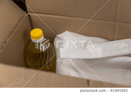 Open donation box with various groceries. Top view. Selective focus. No people. Open donation box with various groceries. Top view. Selective focus. No people. 91905892