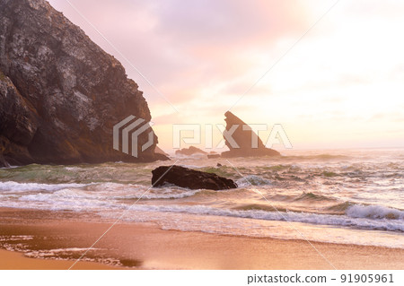 Ocean wild beach stormy weather. Praia da Adraga sandy beach with picturesque landscape background, Sintra Cascais, Portugal Ocean wild beach stormy weather. Praia da Adraga sandy beach with picturesque landscape background, Sintra Cascais, Portugal 91905961