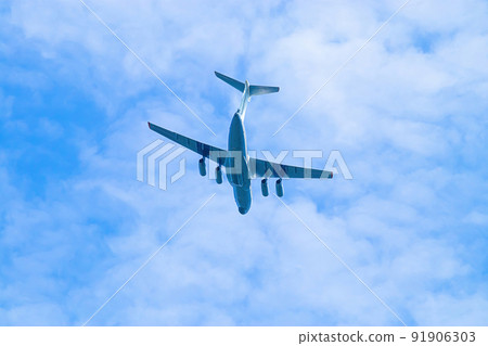 Airplane is flying in blue sky. Commercial passenger and cargo air transportation. Airplane is flying in blue sky. Commercial passenger and cargo air transportation. 91906303