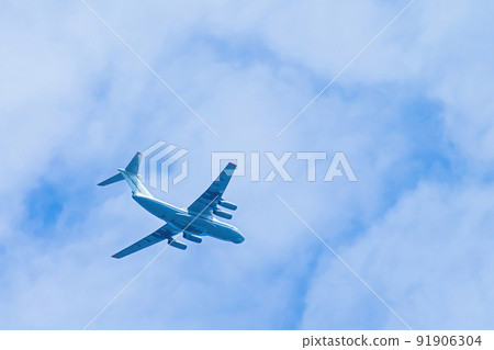Airplane in blue sky. Air cargo transportation. Plane is flying in clouds. Airplane in blue sky. Air cargo transportation. Plane is flying in clouds. 91906304