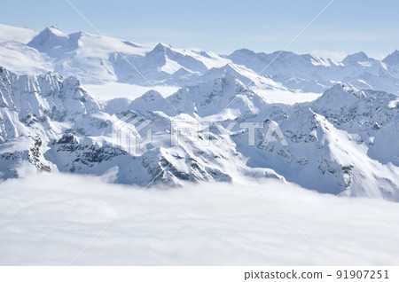 Alpine snow covered peak in the Alps at winter 91907251