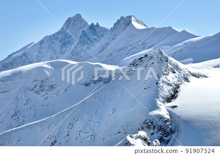 Winter in the Alps with clouds above the mountains Winter in the Alps with clouds above the mountains 91907324