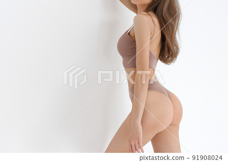 Fitness model with beautiful buttocks behind view. Legs and booty of young slim girl in sexy sports clothing, underpants, underwear standing over white background. Woman beauty and sexy image concept. 91908024