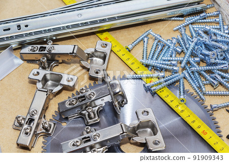 Screws, confirmations for furniture, tape measure, lie on the table. Furniture production Screws, confirmations for furniture, tape measure, lie on the table. Furniture production 91909343