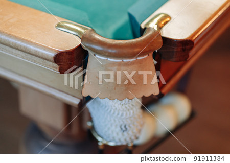 Billiard table with green surface and balls in the billiard club. 91911384