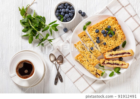 sliced blueberry crumble pie on plate, top view 91912491